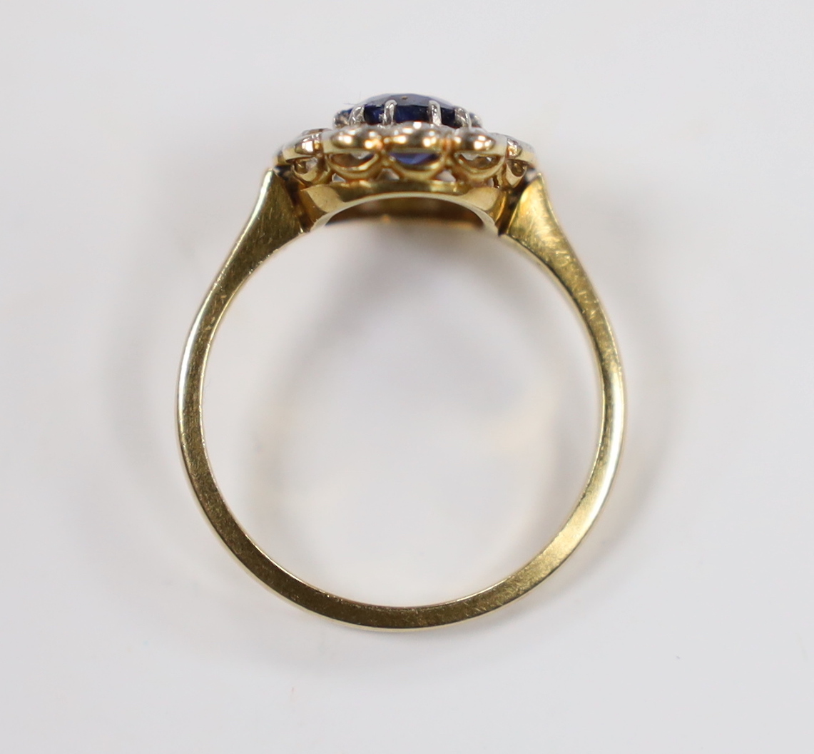 A 1940's/1950's 18ct, sapphire and millegrain set diamond oval cluster ring, size L/M, gross weight 3 grams.